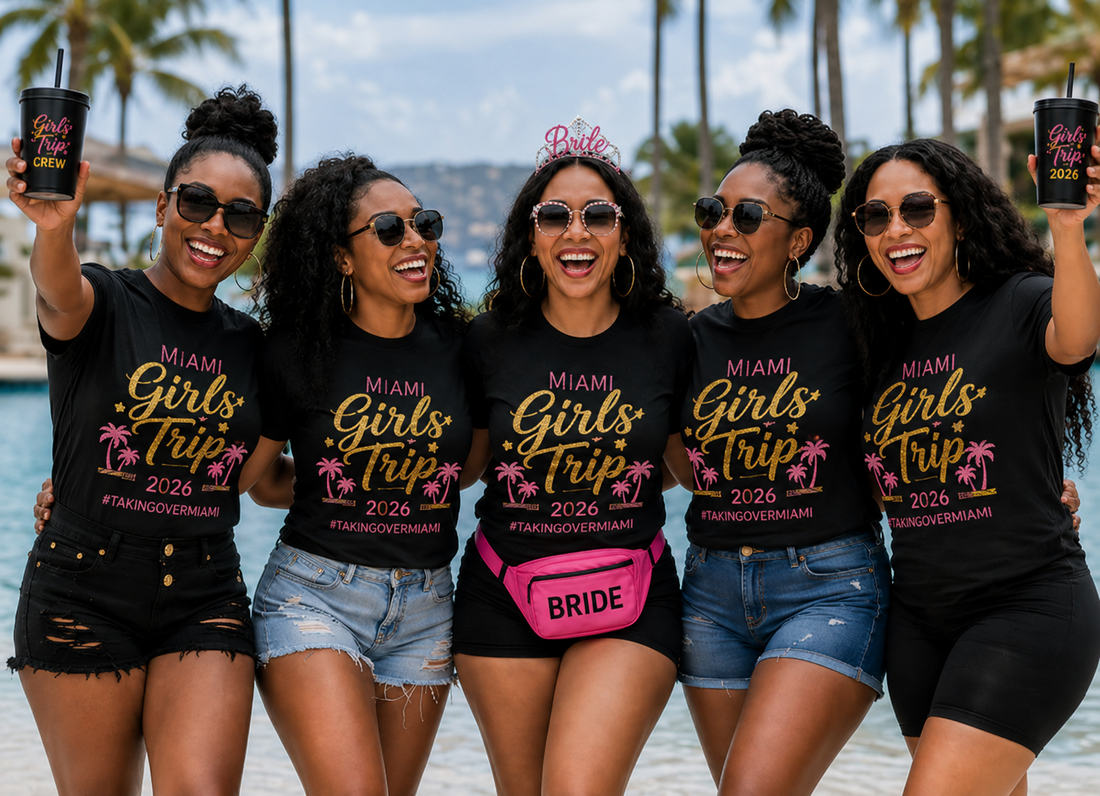 Five women in matching black Miami Girls Trip 2026 tees with #TakingOverMiami, palm trees, beach, and the bride wearing a tiara and pink BRIDE fanny pack — Gifted and Glam Collection